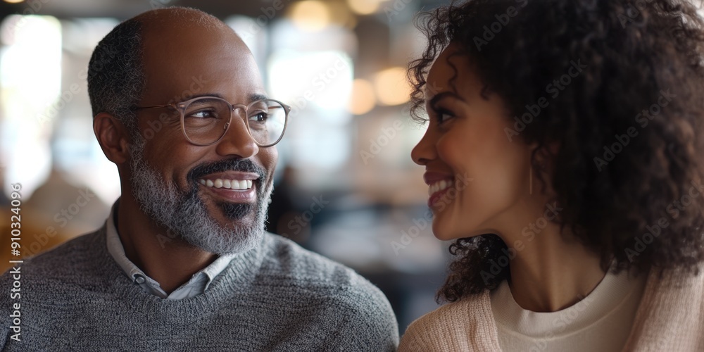 A man and a woman smiling at each other in a moment of joy A man and a woman smiling at each other in a moment of joy
