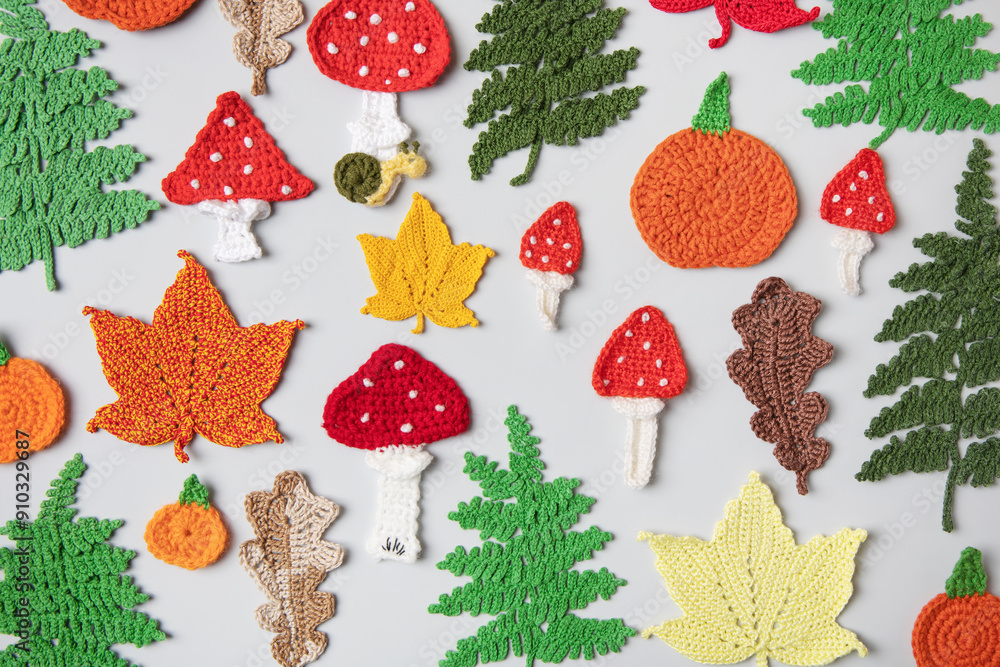 Bright autumn pattern of knitted toys in form leaves of oak, maple, fern and mushroom mushrooms with place for text in center. Knitted autumn story with your own hands. Bright autumn pattern of knitted toys in form leaves of oak, maple, fern and mushroom mushrooms with place for text in center. Knitted autumn story with your own hands.