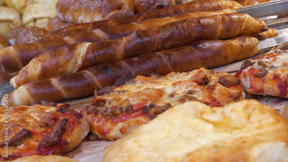 Bakery products on a store counter. Pizza and other baked goods in bread shop, tilt view video Bakery products on a store counter. Pizza and other baked goods in bread shop, tilt view video