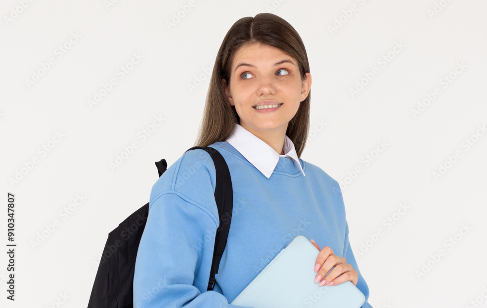 Young woman IT student wear casual clothes blue sweater backpack bag hold closed tablet looking aside on area isolated on white background. High school university college concept Young woman IT student wear casual clothes blue sweater backpack bag hold closed tablet looking aside on area isolated on white background. High school university college concept