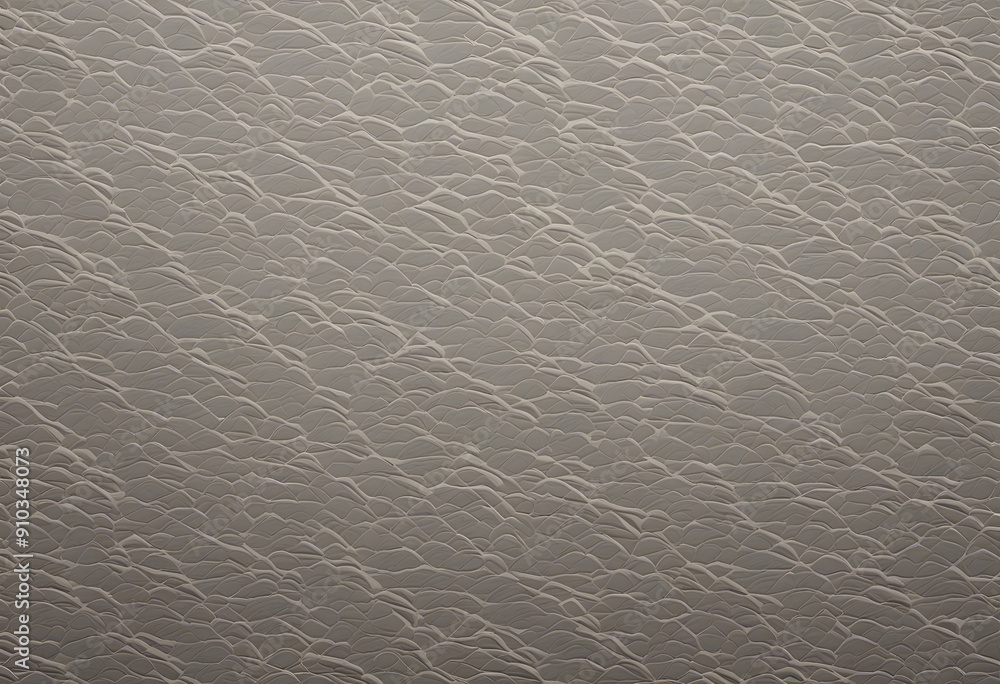 Naklejka premium A textured surface resembling waves or ripples, with a subtle sheen. The color palette is neutral, featuring soft beige and light gray tones, creating a calming effect.