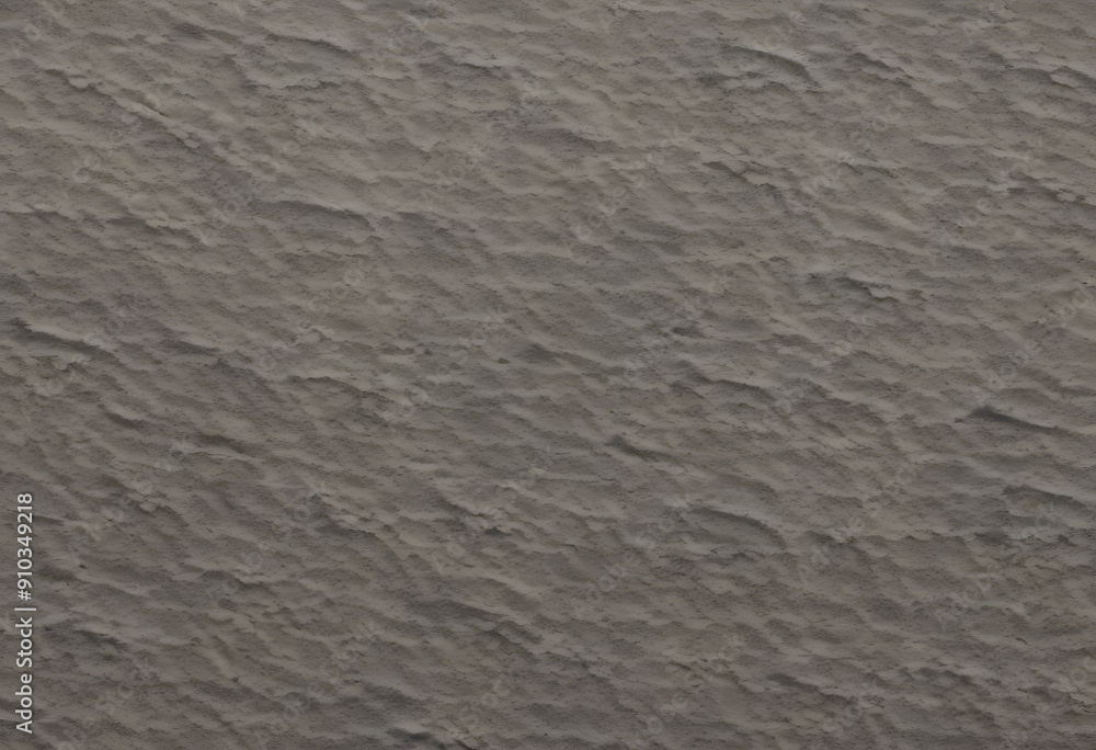 Obraz premium A textured surface with a subtle, wavy pattern in neutral gray tones. The surface appears slightly rough, adding depth and interest.