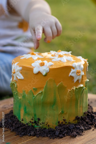 Yellow cake with white flowers cake smash photo