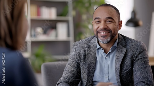 Happy mixed race businessman interviewing well prepared candidate in comfortable office environment.