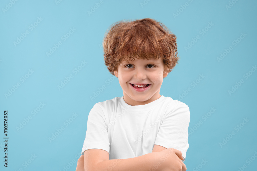 Portrait of cute little boy on light blue background Portrait of cute little boy on light blue background
