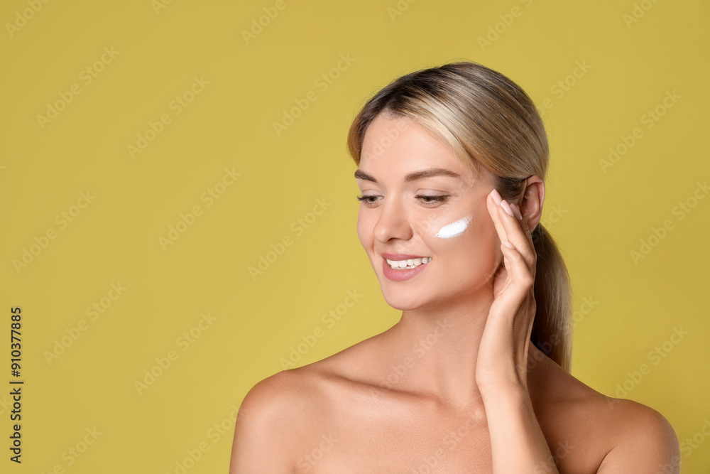 Beautiful woman with cream on her face against olive background, space for text Beautiful woman with cream on her face against olive background, space for text