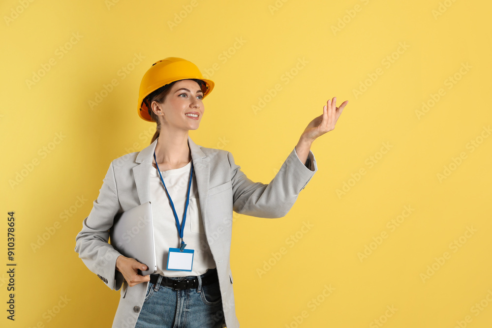 Engineer in hard hat on yellow background, space for text Engineer in hard hat on yellow background, space for text