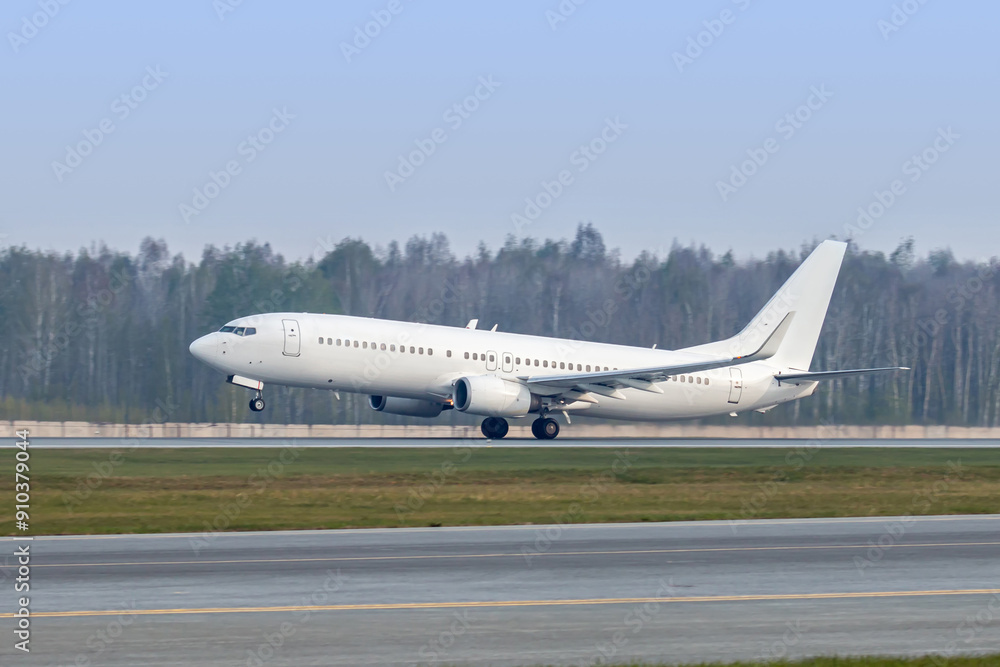 Modern white passenger airliner takes off runway Modern white passenger airliner takes off runway