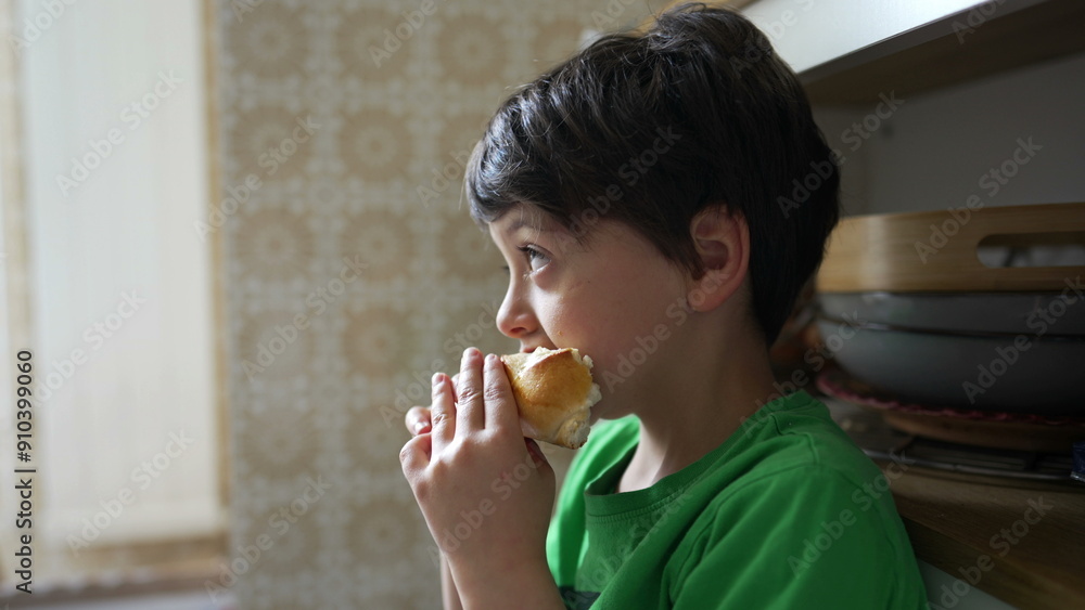 Five-year-old boy captured up-close enjoying a piece of bread, emphasizing a child's simple pleasure in snacking Five-year-old boy captured up-close enjoying a piece of bread, emphasizing a child's simple pleasure in snacking