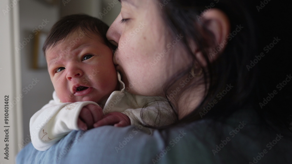Mother holding newborn baby in arms during first week of life, nurturing maternal caring love of mom embracing motherhood, kissing infant on the cheek during first days of existence Mother holding newborn baby in arms during first week of life, nurturing maternal caring love of mom embracing motherhood, kissing infant on the cheek during first days of existence