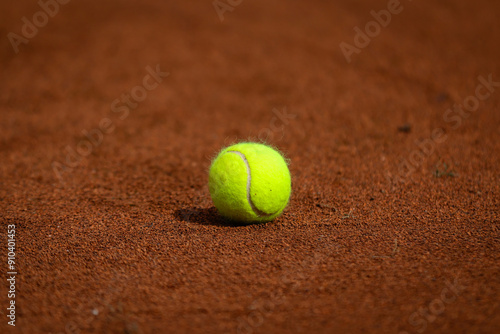 Tennis ball on clay court