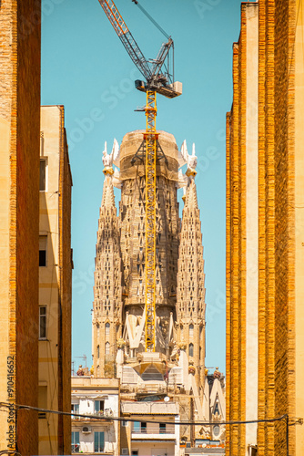 Photography Creative picture of the unfinished Sagrada Familia emerging between buildings in