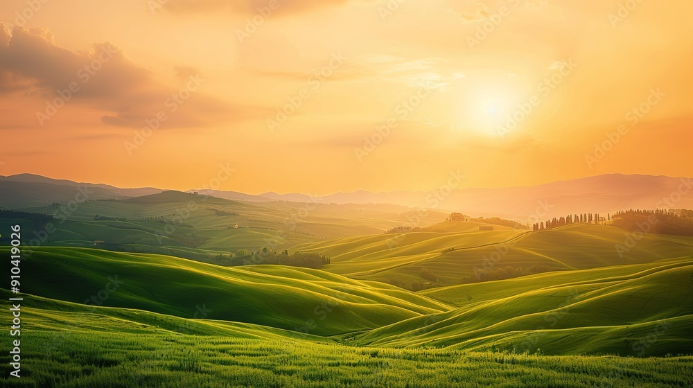 Obraz premium Vibrant Sunset Over Rolling Green Hills in a Serene Landscape