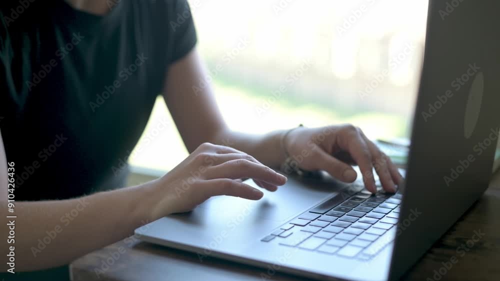 Close-up of a person typing on a laptop at a wooden desk. Ideal for concepts of remote work, productivity, and modern technology. High quality 4k footage Close-up of a person typing on a laptop at a wooden desk. Ideal for concepts of remote work, productivity, and modern technology. High quality 4k footage