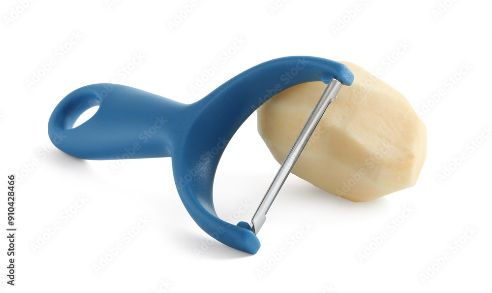 Fresh raw potato and peeler isolated on white Fresh raw potato and peeler isolated on white