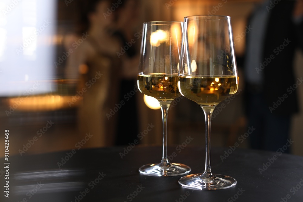 Different tasty wines in glasses on black table indoors, selective focus Different tasty wines in glasses on black table indoors, selective focus