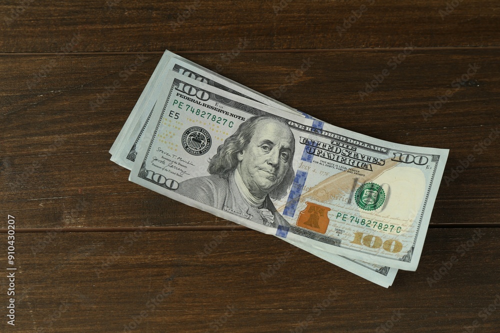 Many dollar banknotes on wooden table, top view Many dollar banknotes on wooden table, top view