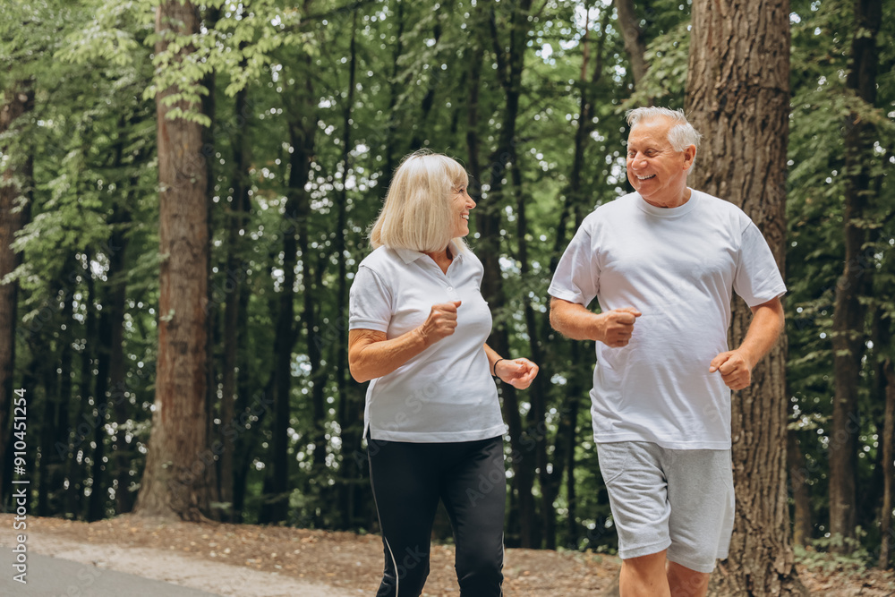 Running, sunshine and senior couple with fitness, exercise and bonding together with challenge. People in park, old man or mature woman with training, retirement and wellness with smile or lens flare Running, sunshine and senior couple with fitness, exercise and bonding together with challenge. People in park, old man or mature woman with training, retirement and wellness with smile or lens flare