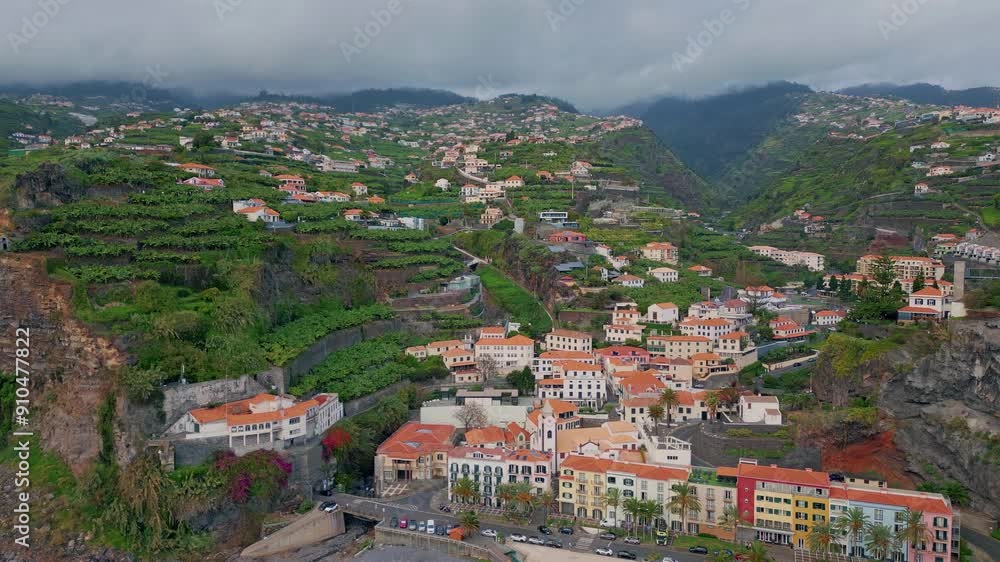 Aerial view coastal village with red roofs. Beautiful Madeira travel destination Aerial view coastal village with red roofs. Beautiful Madeira travel destination