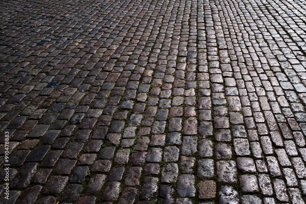 Fototapeta premium Stone road. Pavement texture. Stonework background for design. Granite cobblestoned pavement background. Abstract background of cobblestone pavement.