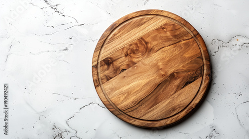 Empty wooden round board on white stone kitchen table top view. Wooden pizza plate, copy space. photo