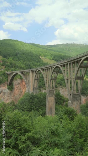 Djurdjevica Bridge, Tara River Canyon, Tepca, Montenegro. View of the bridge, forest and mountains photo