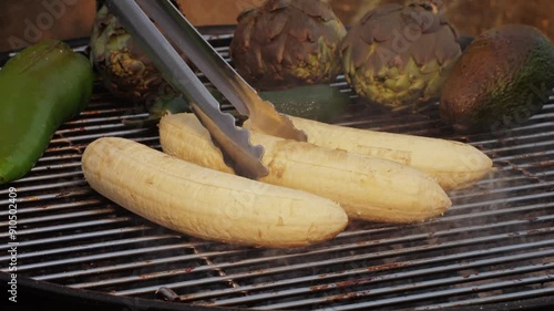 Grilled Banana on fire, latin american vegan grill with avocado and pepper, thai or Ecuadorian Street food. African traditional food on grill.  photo