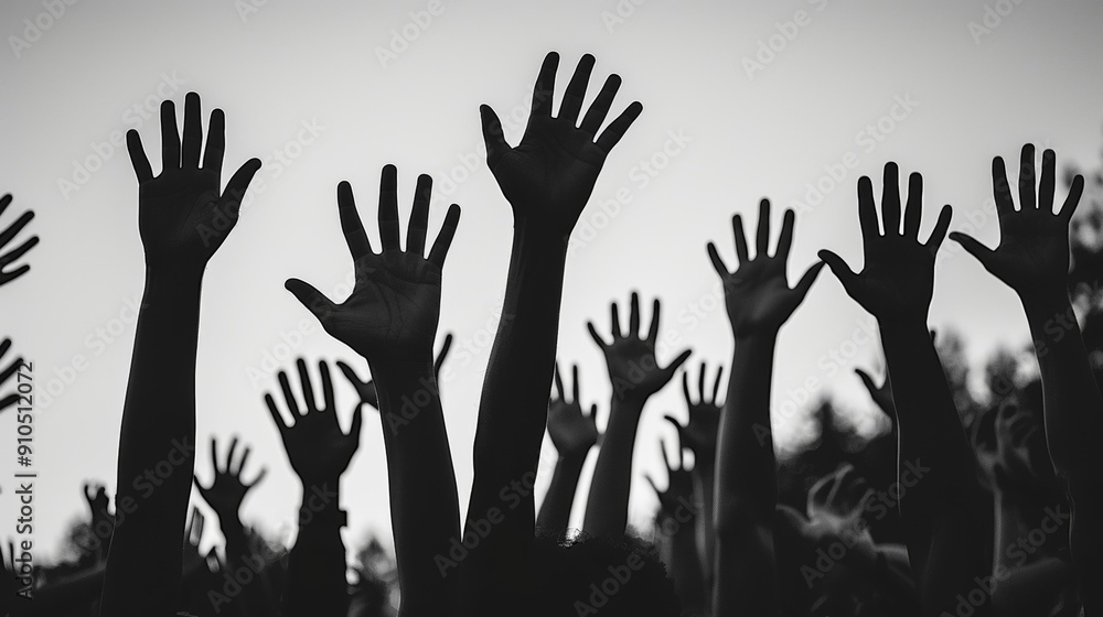 Diverse group of raised hands in silhouette, black and white image, symbolizes unity, support, human rights movement, protest gathering, freedom and equality fight
