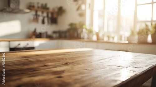 A plain, bare wooden table sits in a well-lit kitchen. The background is a blur of bright white and warm golden sunlight.