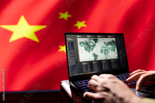 Fotografie Chinese terrorist uses software on notebook to spread ideology on internet, isolated over China flag