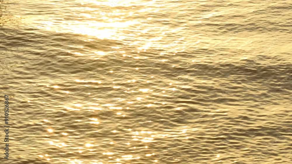 bokeh and blur of waves on the sea at sunset, the reflection of sunlight on the surface of the water creates moving sparkles, a natural background with golden orange gradations. bokeh and blur of waves on the sea at sunset, the reflection of sunlight on the surface of the water creates moving sparkles, a natural background with golden orange gradations.