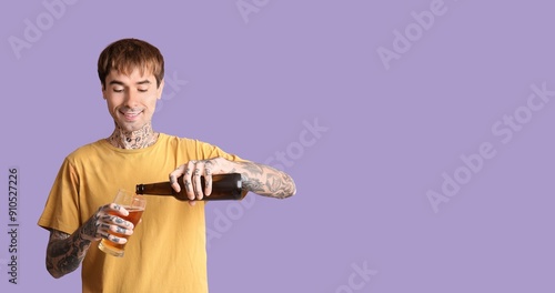 Young tattooed man drinking...