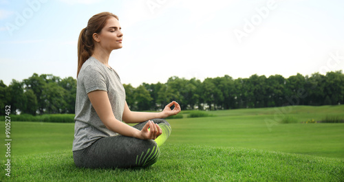 Young woman practicing yoga...