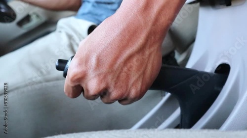 A car driver pulls the handbrake