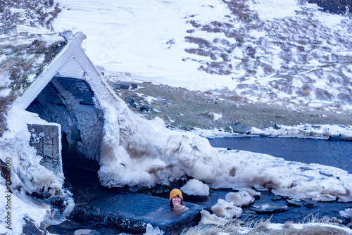 Girl bathing in Hrunalaug Warm Natural Bath, Fludir, Iceland photo