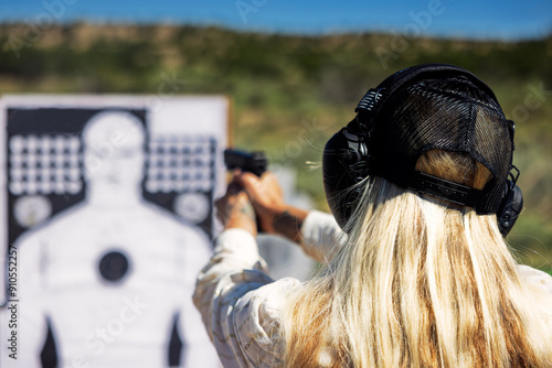 Blond woman at gun range 