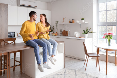 Happy young couple in kitchen