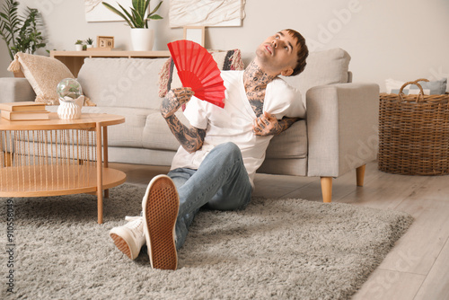Young tattooed man with han...