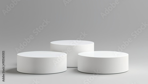 white podiums, round shape with straight sides standing next to...