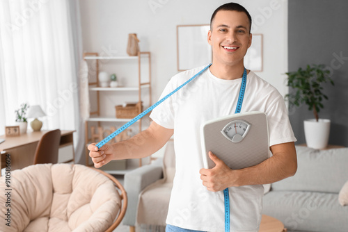 Young man with weight scale...