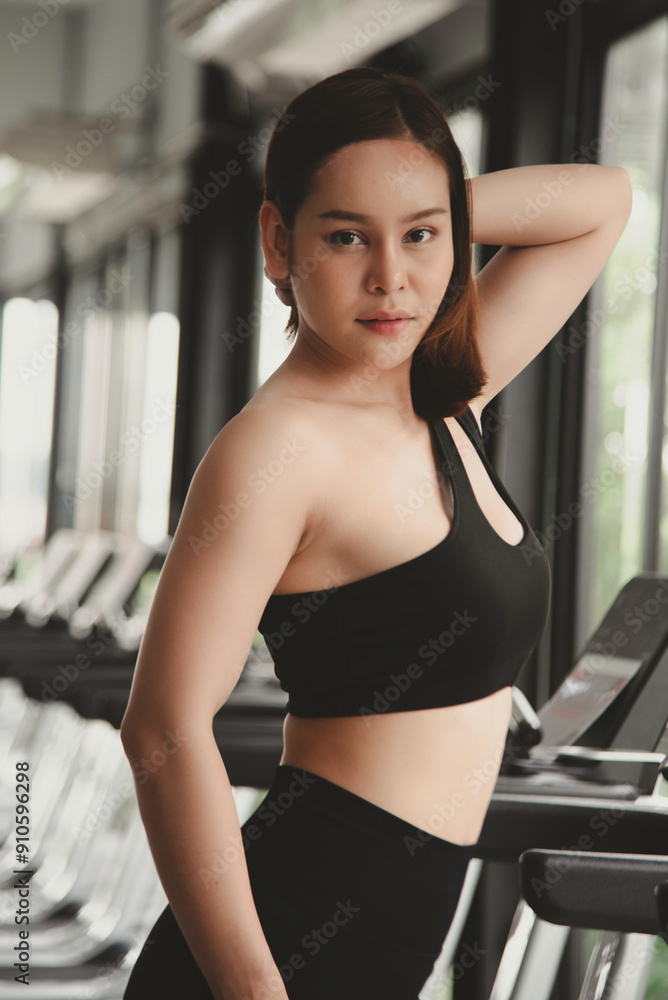 portrait beautiful young woman in fitness style sit relax and smiling on chair at exercise class indoor. heathy concept.