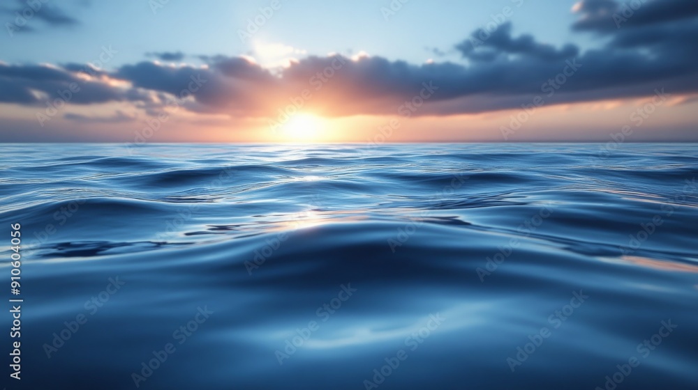 Sunset over calm ocean waves with partly