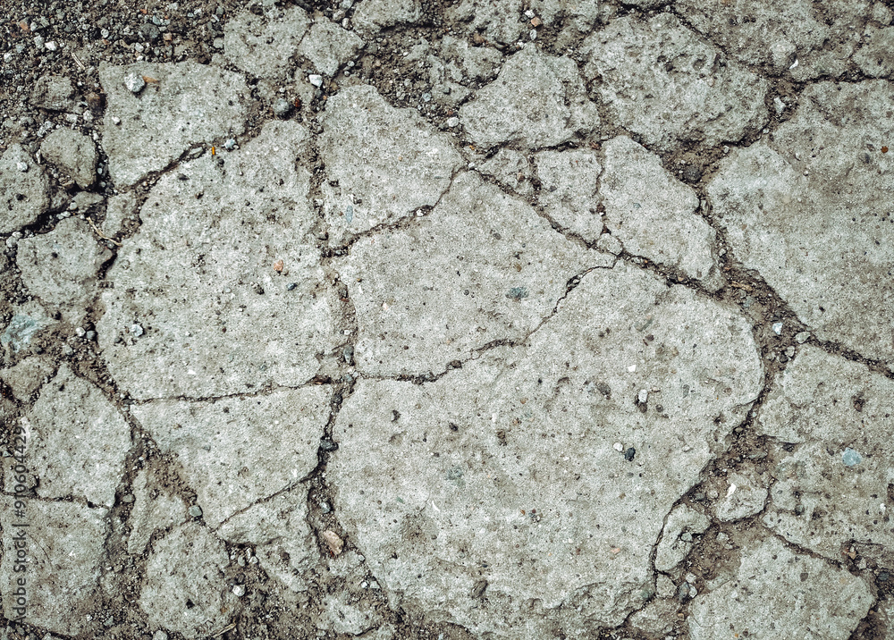 Obraz premium Top view of stones and old gray cracked concrete. Grunge background.