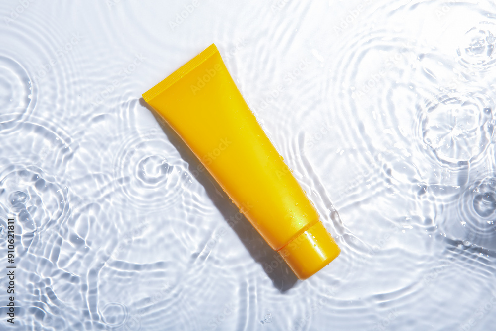 Cosmetic product. Tube with cream in water on light background, top view Cosmetic product. Tube with cream in water on light background, top view