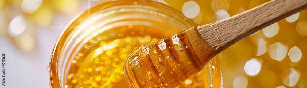 Close-up of golden honey with a wooden dipper. Close-up of golden honey with a wooden dipper.