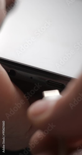 USB-C cable macro plugin to smartphone slow motion, vertical view