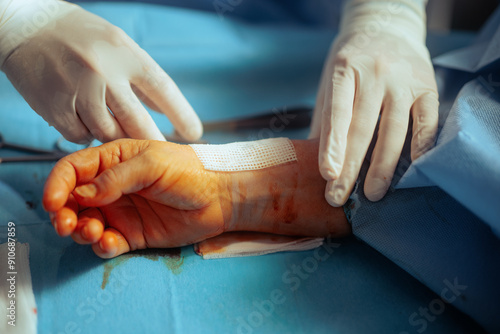 Doctor Applying a Bandage over the Fresh Surgical Operation. Surgeon giving post operator assistance to patient 
 photo