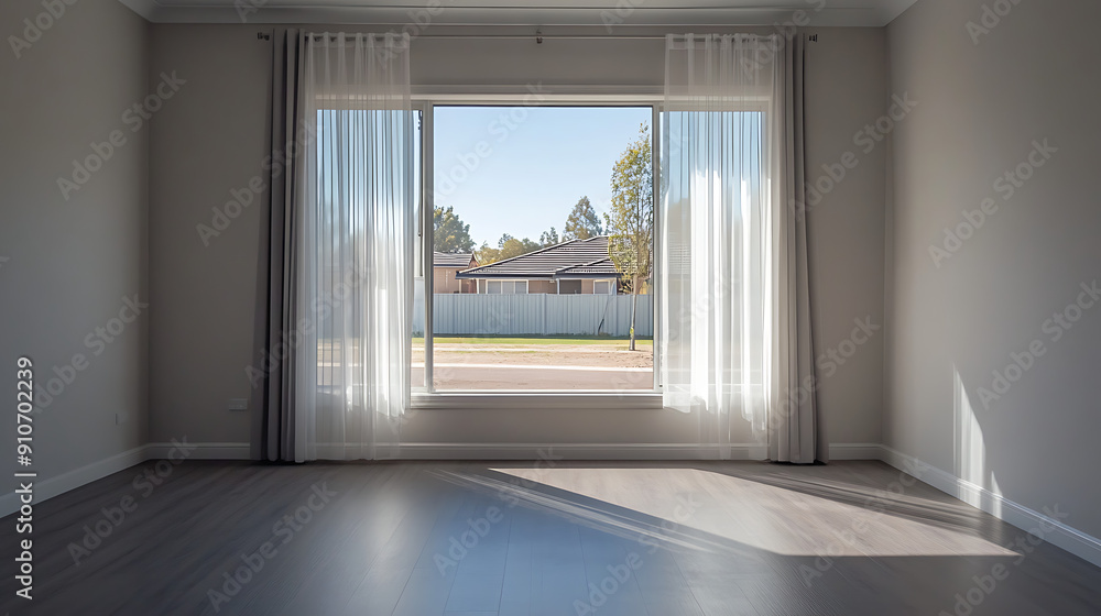 Obraz premium A photo of an empty room with two windows, white walls, and grey trim