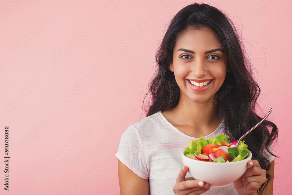 Smiling Woman Holding Fresh Salad Bowl on Pink Background Illustrating Healthy Eating and Happiness Smiling Woman Holding Fresh Salad Bowl on Pink Background Illustrating Healthy Eating and Happiness