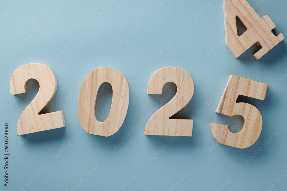 Wooden 2024 to 2025 new year blue background.